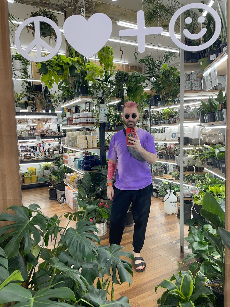 Rob taking a mirror selfie in a plant shop